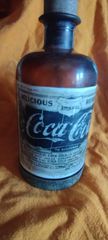 μπουκαλι ΣΠΑΝΙΟ ΣΥΛΛΕΚΤΙΚΟ ΚΟΜΜΑΤΙ .Η coca cola ΜΕ ΜΠΡΟΥΤΖΙΝΗ ΒΑΣΗ ΚΑΙ ΣΦΡΑΓΙΔΑ 1896 αρχικα χρησιμοποιήθηκε σαν φαρμακο και αργοτερα σαν αναψυκτικο Συλλεκτικόλη Κόκα κόλα σπάνιο μπουκάλι εποχής 1896