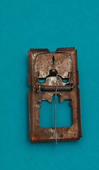 A 1960s-1970s stamped iron mousetrap